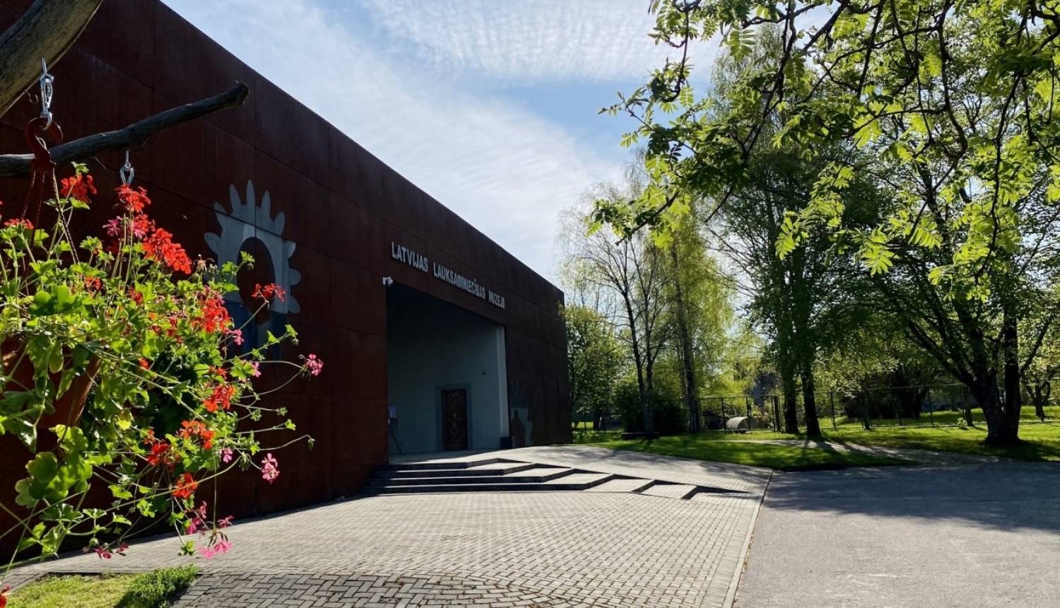 Muzeja skats no centrālo durvju puses saulainā, pavasara dienā
